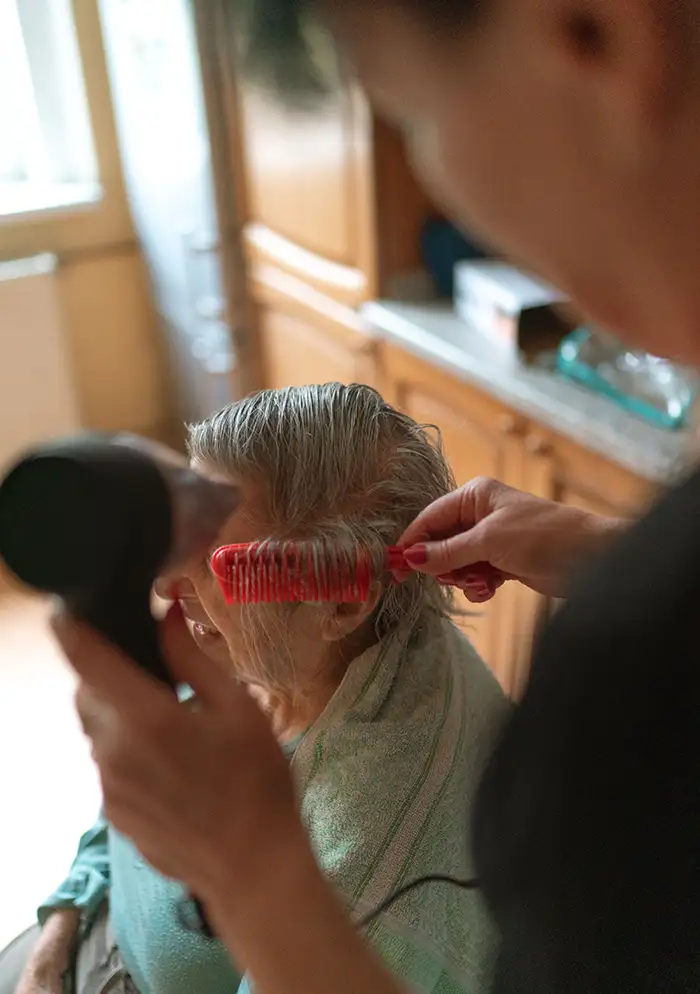 carer-helping-old-lady-for-grooming